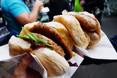 Close-up of hand holding burger