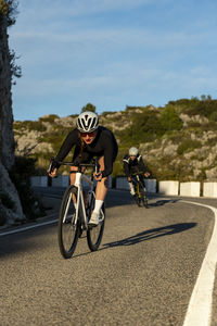Sportswoman descending on mountain pass in alicante, spain