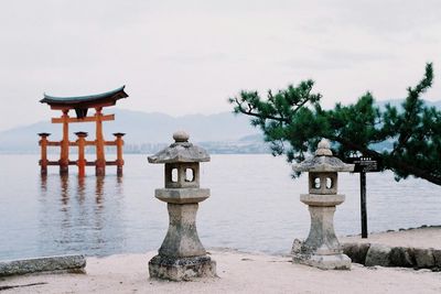 Built structure by sea against sky