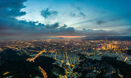 High angle view of illuminated buildings against sky at sunset