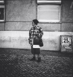 Full length of woman standing on wall