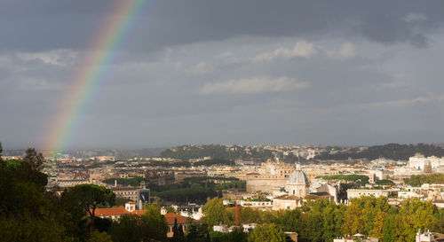 Aerial view of rainbow over city buildings