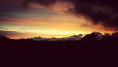 Scenic view of mountains against sky at sunset