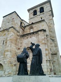 Low angle view of statue against building