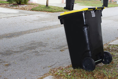 Close-up of garbage can on street