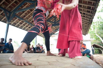 People looking at performers performing on covered footpath