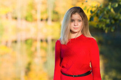 Portrait of beautiful young woman standing outdoors