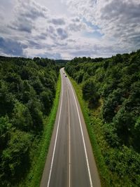 Road amidst trees against sky