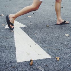 Low section of woman on road