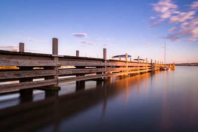 Jetty of lake altmühlsee during sunset on summer evening