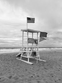 Lifeguard hut on beach against sky