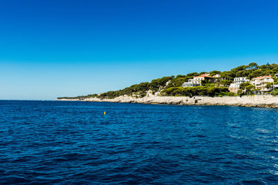 Scenic view of sea against clear blue sky