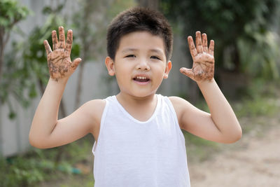 Portrait of boy standing in park