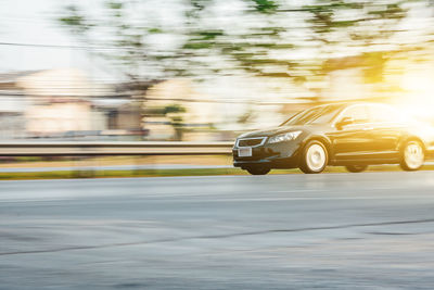 Blurred motion of car on road in city