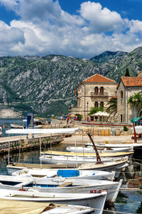 Scenic view of townscape and mountains against sky