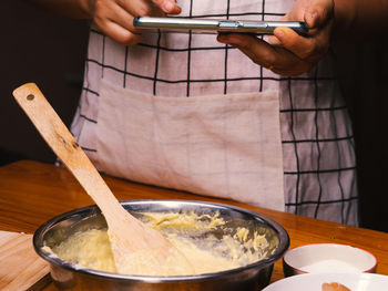 Midsection of man preparing food on table