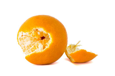 Close-up of orange fruit against white background