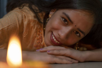 Close-up portrait of young woman lying down on floor