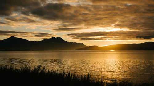 Scenic view of lake against sky during sunset