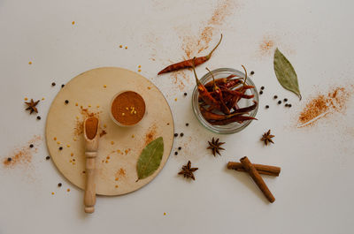 Dried pepper in pods and ground spread out view from the top on a light background