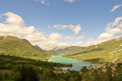 Scenic view of lake and mountains against sky