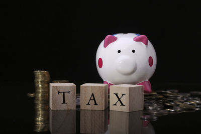 Close-up of toys on table against black background