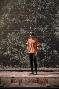 Young man standing on railroad station platform