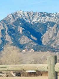 Scenic view of mountains against blue sky