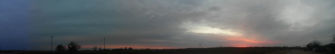 Silhouette trees on landscape against sky at sunset