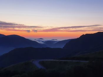 Scenic view of silhouette mountains against sky during sunset