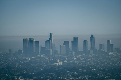 Modern buildings in city against clear sky