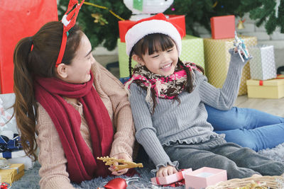 Mother and daughter enjoying with christmas present at home