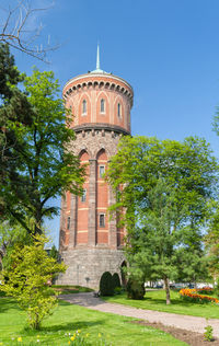 Built structure by trees against sky