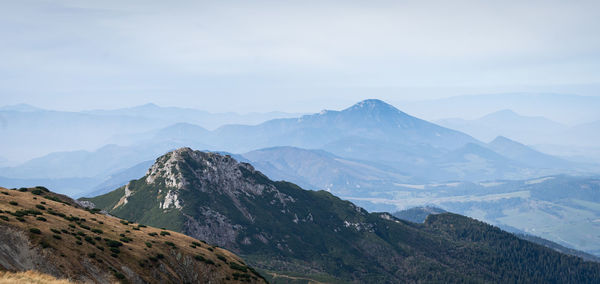 Autumn landscape with mountains, forest and more mountains in foggy background, slovakia, europe