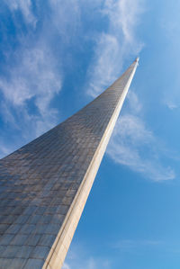 Low angle view of crane against blue sky