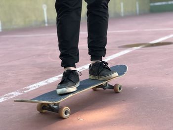 Low section of man skateboarding on skateboard