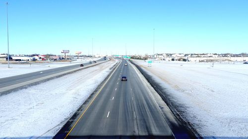 Cars on road against clear sky