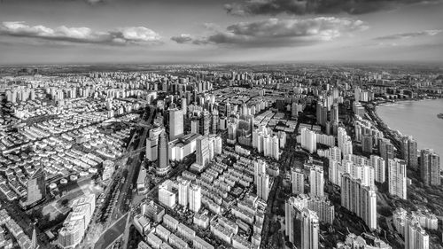 High angle view of modern buildings in city against sky