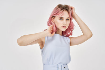 Portrait of young woman against white background