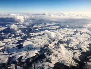 Aerial view of snowcapped mountain against sky