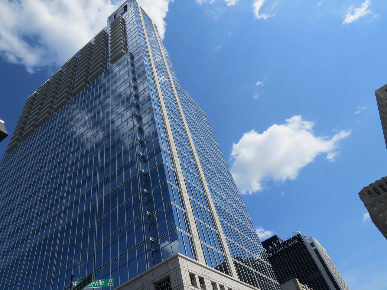 building exterior, architecture, built structure, low angle view, city, modern, sky, skyscraper, office building, tall - high, tower, blue, building, cloud - sky, glass - material, cloud, reflection, day, outdoors, no people