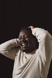 Cheerful mid adult man over black background