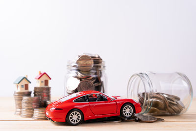 Toy car on table against white background