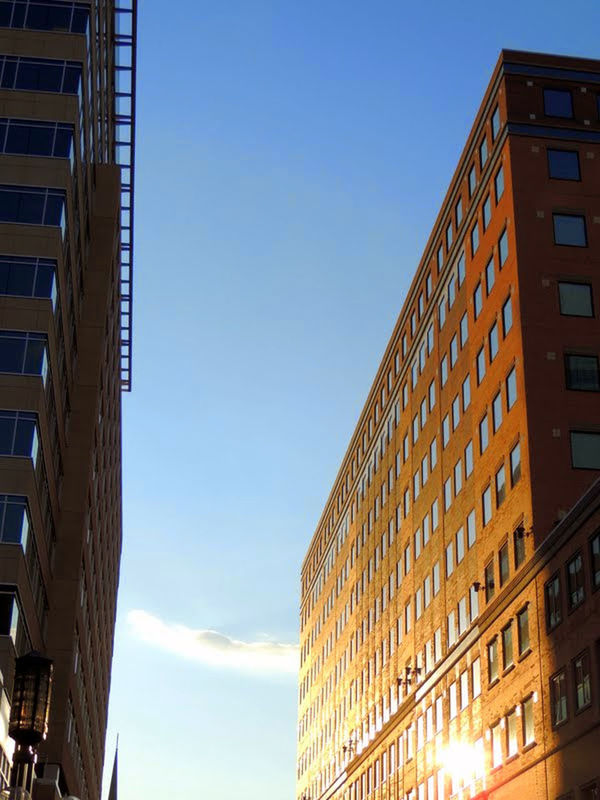 LOW ANGLE VIEW OF BUILDINGS AGAINST BLUE SKY