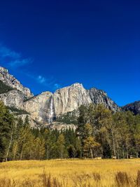 Scenic view of landscape against blue sky