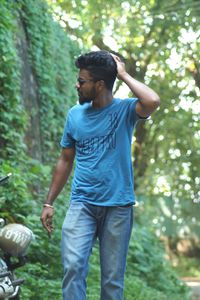 Full length of man standing by tree in forest