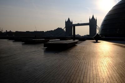 View of bridge over river at sunset