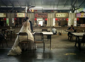 Rear view of a bride sitting at the café