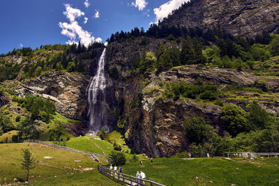 Scenic view of waterfall against sky