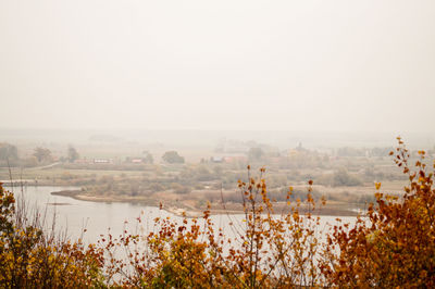 Scenic view of landscape against sky during foggy weather